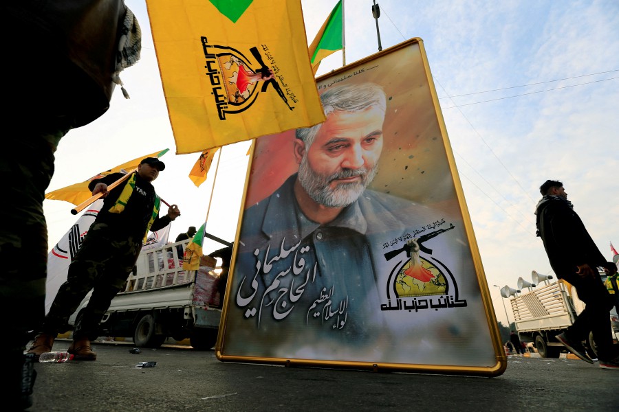 Kataib Hezbollah Iraqi militia hold the picture of the Iranian Major-General Qassem Soleimani, as they gather ahead of the funeral of the Iraqi militia commander Abu Mahdi al-Muhandis, who was killed in an air strike at Baghdad airport, in Baghdad, Iraq, January 4, 2020. REUTERS FILE PIC