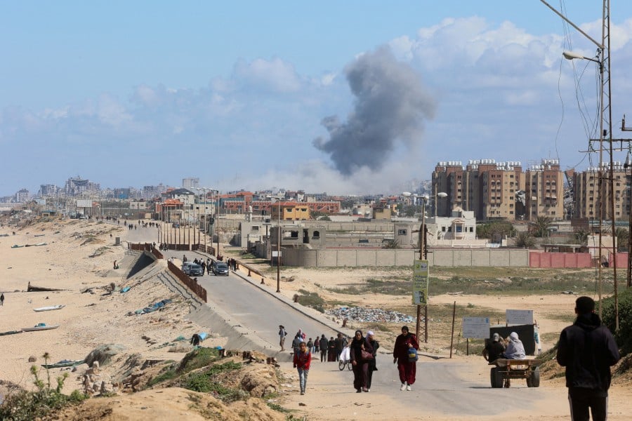Smoke rises following an Israeli strike as Palestinians fleeing north Gaza due to Israel’s military offensive move southward, amid the ongoing conflict between Israel and Hamas, at the central Gaza Strip, March 15, 2024. REUTERS FILE PIC