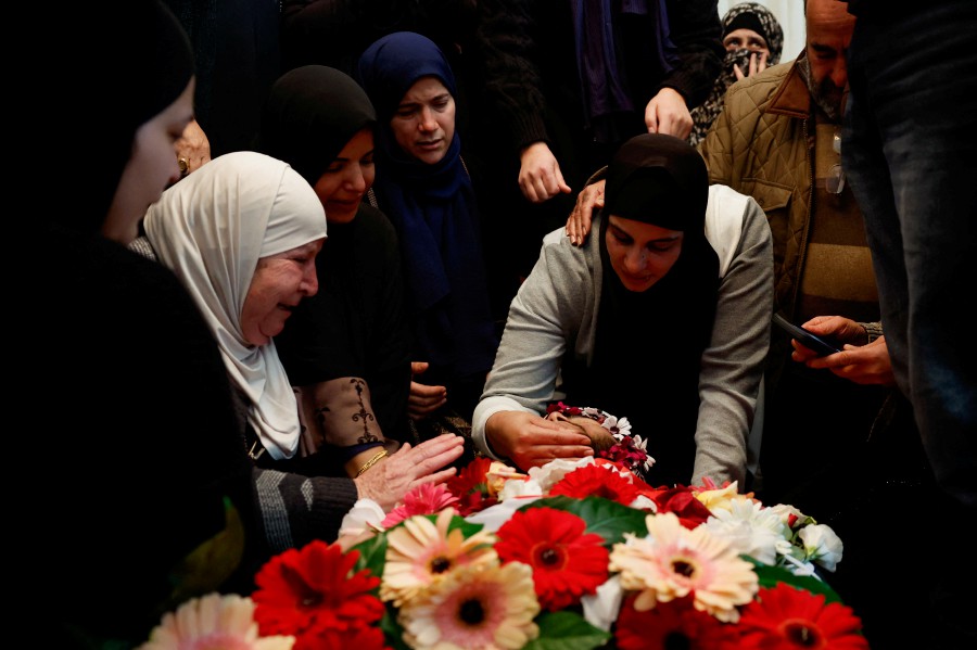 Mourners react next to the body of American-Palestinian Tawfiq Ajaq, 17, who according to Palestinian officials was killed by the Israeli security forces, during his funeral near Ramallah in the Israeli-occupied West Bank January 20, 2024. REUTERS PIC