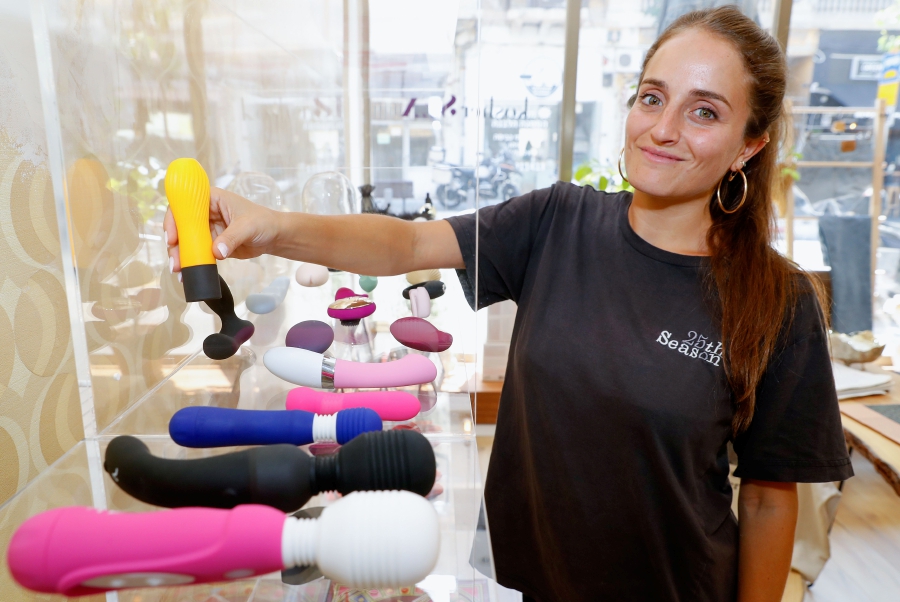 Chana Boteach, daughter of Rabbi Shmuley Boteach, poses for a picture with some of the products on sale in her kosher sex shop in the center of the Israeli coastal city of Tel Aviv.-AFP