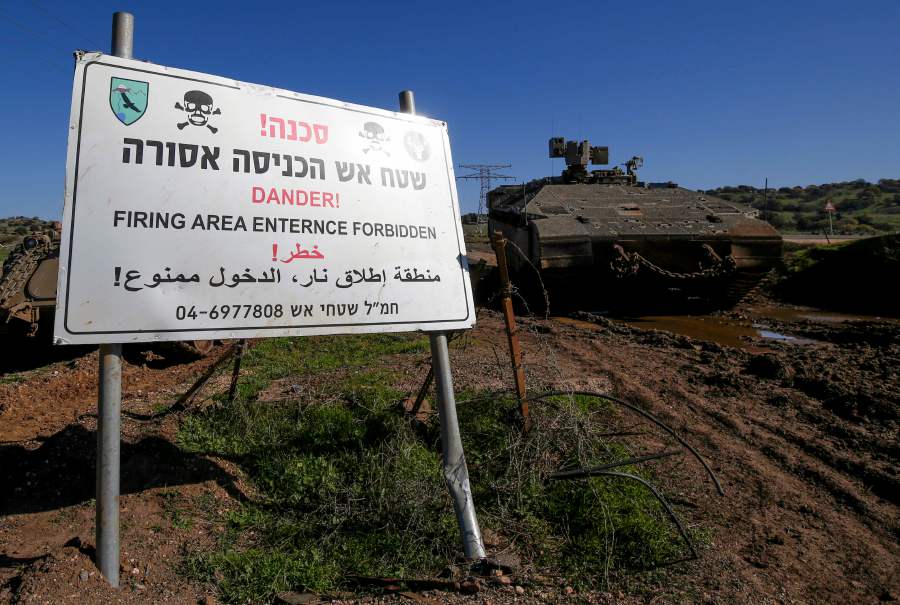 An Israeli military vehicle is pictured near a warning sign during a military drill in the Israeli-annexed Golan Heights, on December 30, 2020. - Israeli air strikes in Syria targeting the pro-Damascus Lebanese Hezbollah group and Syrian air defence forces, killed one Syrian soldier and wounded five others, a war monitor said today. - AFP file pic