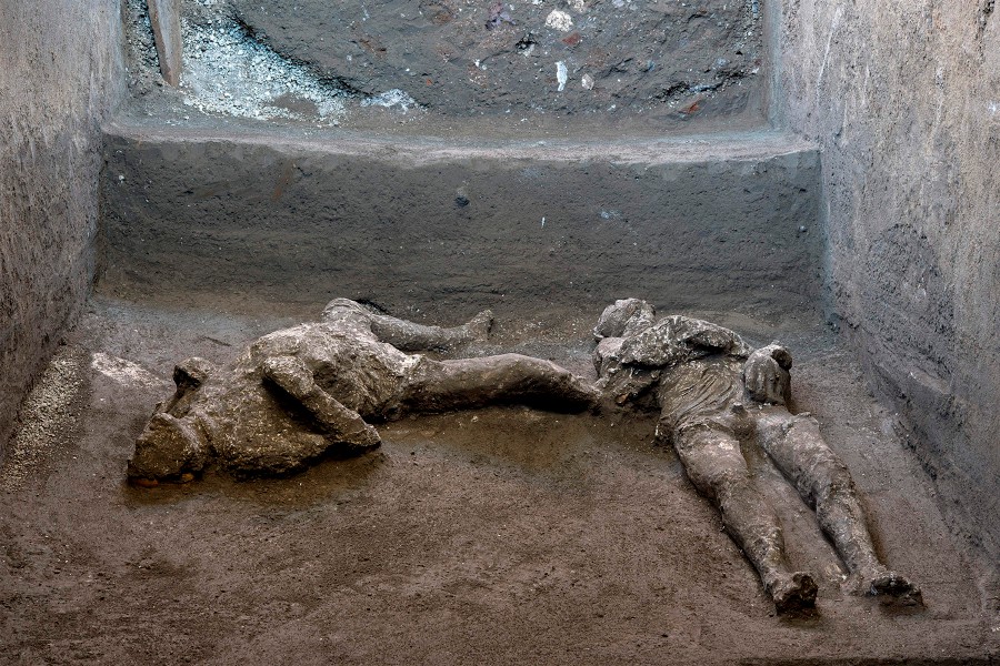 This undated photo handout on November 21, 2020 by the Pompeii Archaeological Park shows casts of the bodies of two men, a 40-year-old master and his young slave, after they were found during recent excavations of a Villa in Civita Giuliana in the outskirts of Pompeii, as Park officials said conditions were optimal to get casts of the victims, following the technique perfected in 1863 by Giuseppe Fiorelli. - The ancient Roman city of Pompeii was engulfed under a hail of volcanic ash after nearby Mount Vesuvius erupted in the year 79. Vesuvius' eruption covered the in a toxic, metres-thick layer of volcanic ash, gases and lava flow which then turned to stone, encasing the city, allowing an extraordinary degree of frozen-in-time preservation both of city structures and of residents unable to flee. (Photo by Handout / POMPEI ARCHAEOLOGICAL PARK / AFP)
