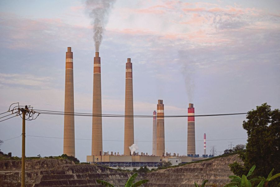 Smokestacks belch noxious fumes into the air from a massive coal-fired power plant on the Indonesian coast, a stark illustration of Asia's addiction to the fossil fuel which is threatening climate targets. (Photo by BAY ISMOYO / AFP) 