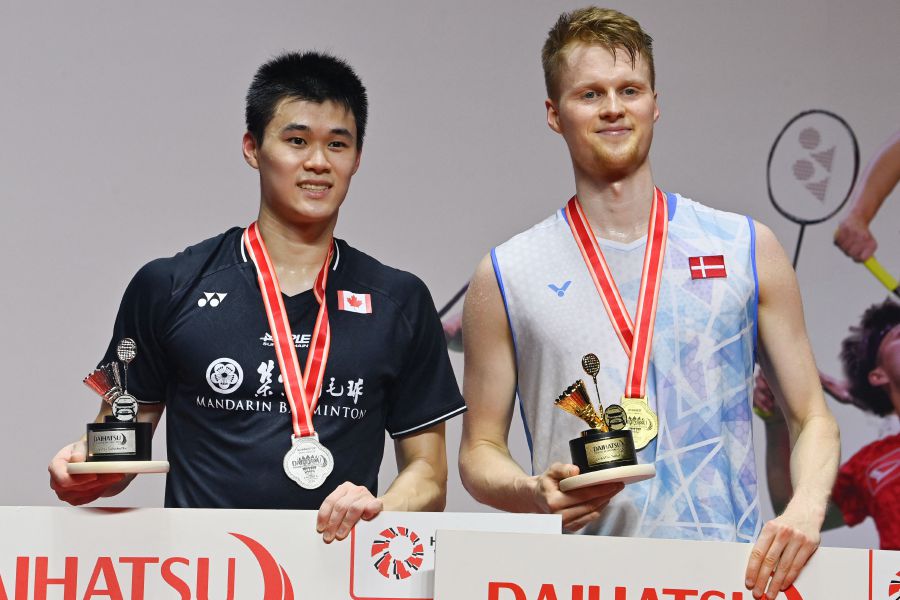 Winner Anders Antonsen of Denmark (right) poses on the podium with runner up Brian Yang of Canada following their men’s singles final match at the Indonesia Masters badminton tournament in Jakarta on January 28, 2024. - AFP pic