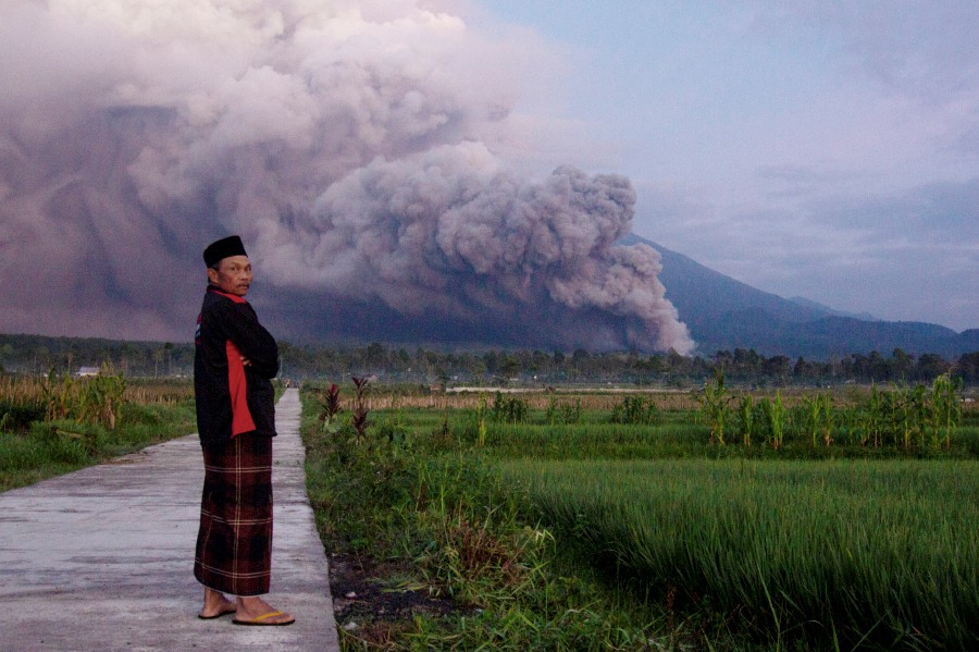 A man looks on as Mount Semeru releases volcanic materials during an eruption on Sunday in Lumajang, East java, Indonesia. Indonesia’s highest volcano on the country’s most densely populated island of Java erupted Sunday. AP PIC