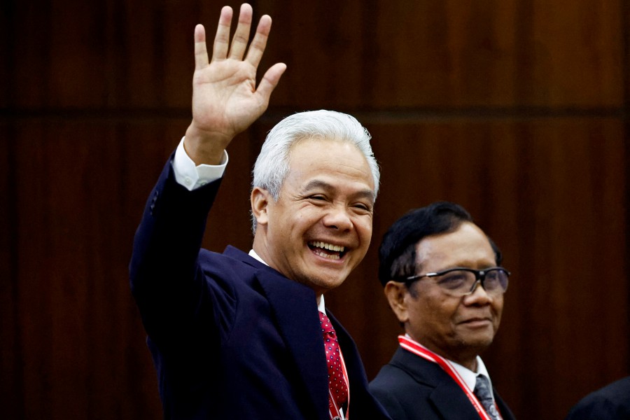 Losing presidential candidate Ganjar Pranowo (Left) waves alongside his running mate Mahfud MD in the courtroom as a court delivers its verdict on two challenges to the outcome of February's presidential election after losing candidates petitioned for a re-run and alleged the state had interfered in favour of the winner Prabowo Subianto, at the Constitutional Court building in Jakarta, Indonesia, today (April 22). — REUTERS