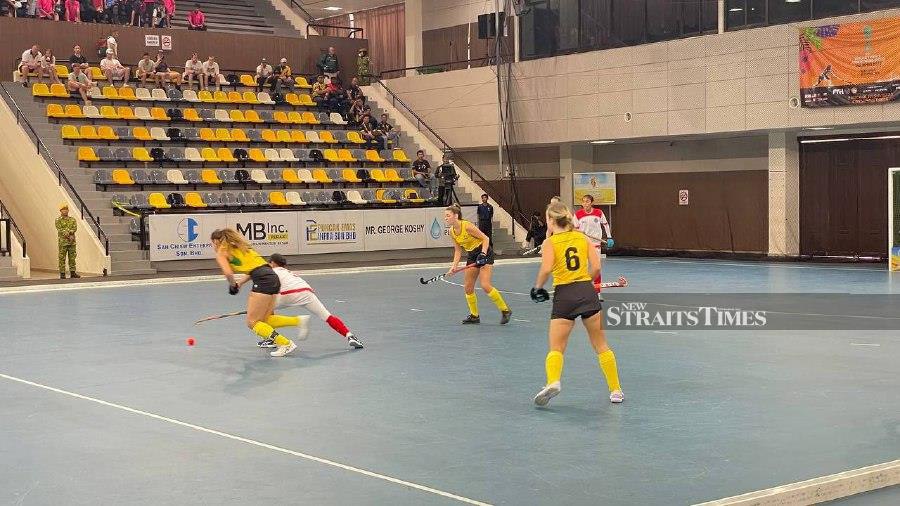 Malaysia (white) in action against Australia in today’s Tuanku Zara Cup match in Ipoh. 