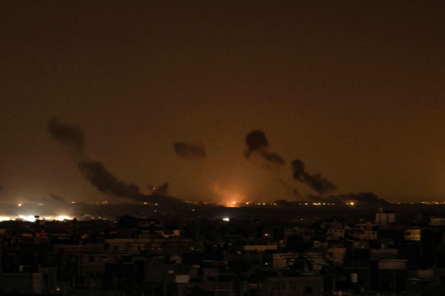 This picture taken from Rafah, shows smoke and fire rising above buildings during Israeli strikes on eastern Khan Yunis in the southern Gaza Strip, amid ongoing battles between Israel and the Palestinian fighters Hamas. - AFP pic