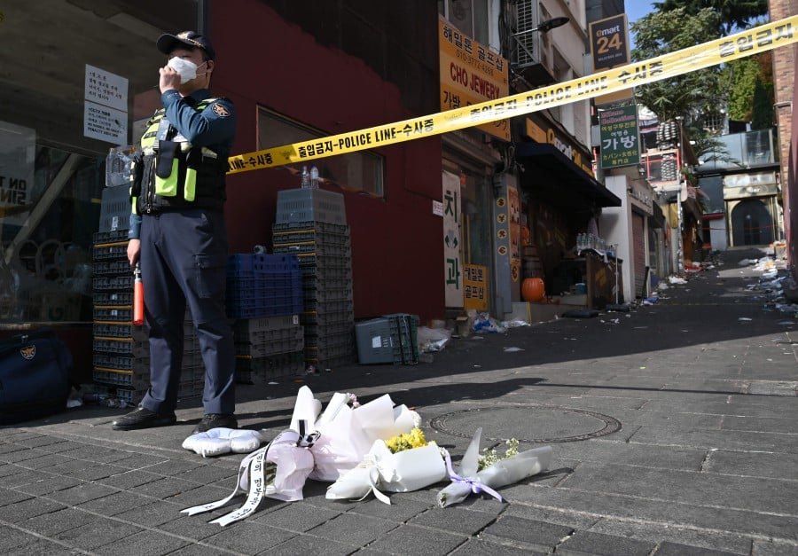 Flowers are laid at the scene of a Halloween stampede in the capital's popular Itaewon district in Seoul. - AFP PIC`