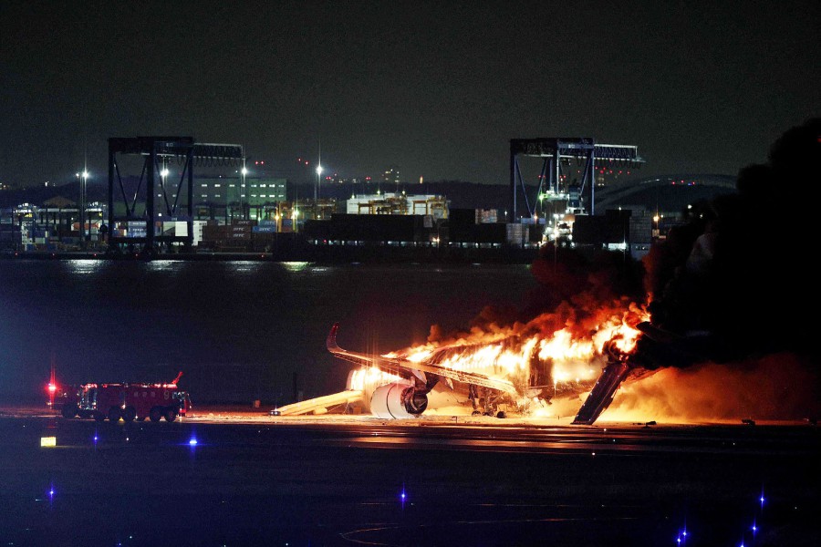 A Japan Airlines plane on fire on a runway of Tokyo's Haneda Airport on January 2, 2024. A Japan Airlines plane was in flames on the runway of Tokyo's Haneda Airport on January 2 after apparently colliding with a coast guard aircraft, television reports said. AFP PIC