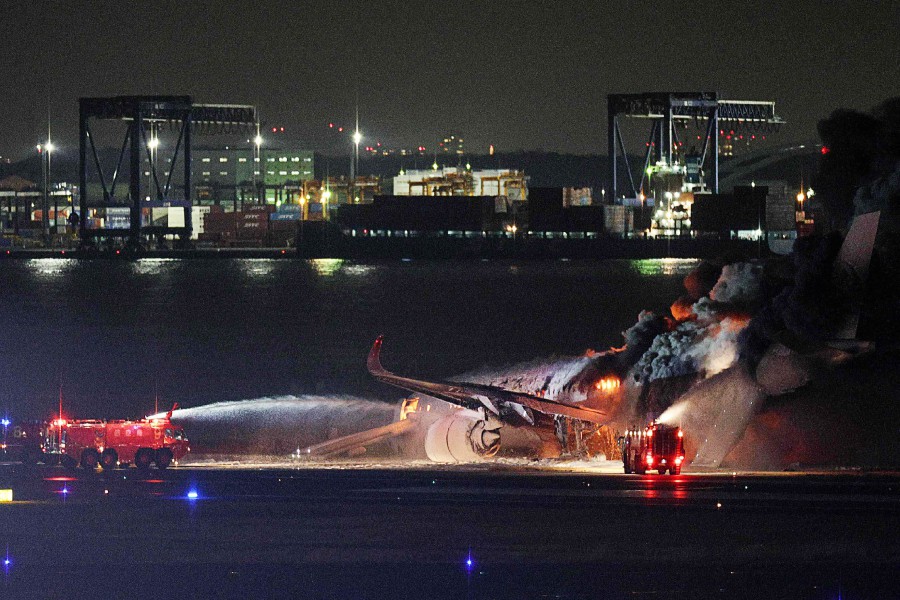 Firefighters attempting to extinguish a fire on a Japan Airlines plane on a runway of Tokyo's Haneda Airport on January 2, 2024. A Japan Airlines plane was in flames on the runway of Tokyo's Haneda Airport on January 2 after apparently colliding with a coast guard aircraft, television reports said. AFP PIC