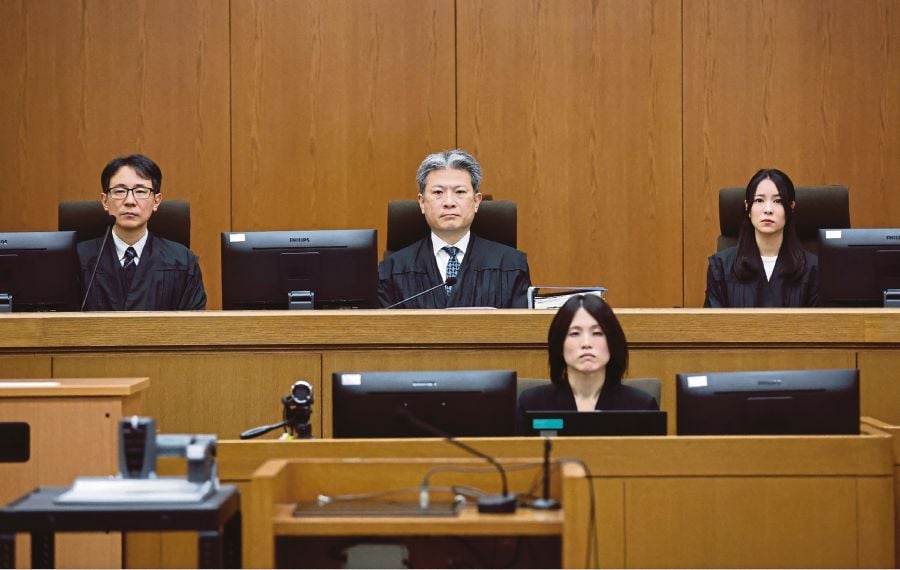 Presiding Judge Keisuke Masuda (top, centre) of Kyoto District Court and others attend a courtroom where defendant Shinji Aoba's sentencing hearing in Kyoto. (Photo by JIJI Press / AFP) 