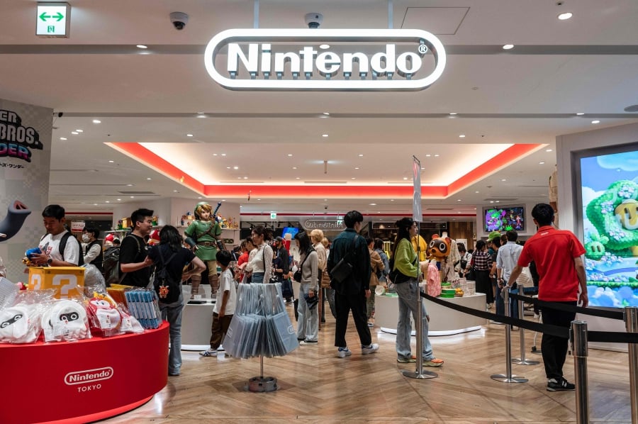 People look at merchandise on display at a Nintendo store in central Tokyo. (Photo by Richard A. Brooks / AFP)