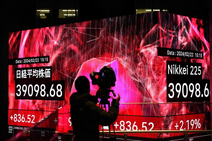 Asian stocks were muted as investors kept watch for possible intervention by Japanese authorities to stop the yen's decline and awaited US inflation data later on Wednesday for clues about future interest rate moves. (Photo by Kazuhiro NOGI / AFP)