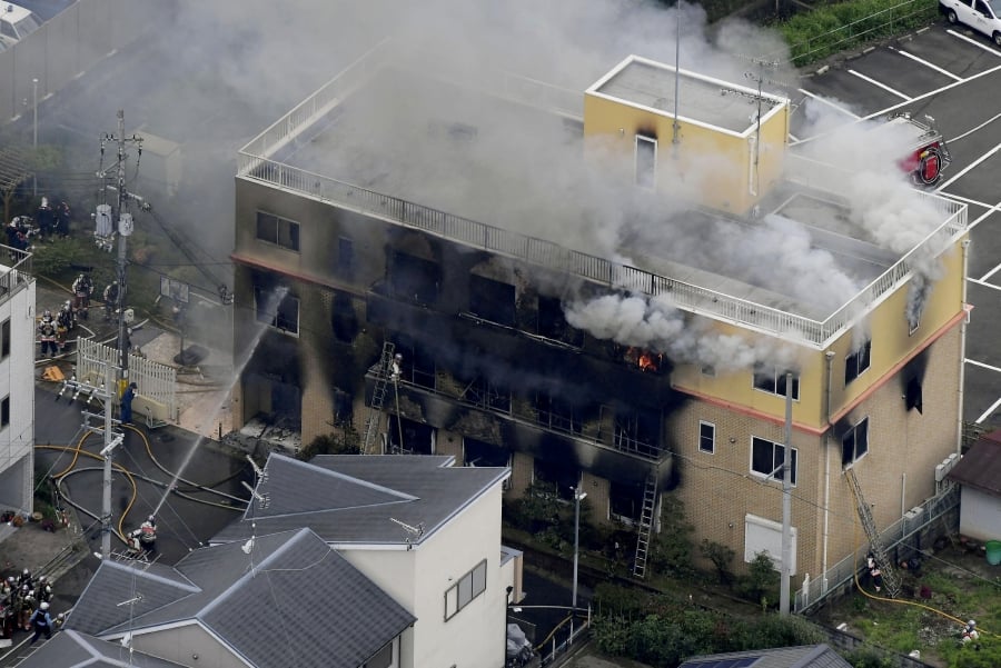 (FILE PHOTO) Firefighters battling fires at the site where a man started a fire after spraying a liquid at a three-story studio of Kyoto Animation Co. in Kyoto, western Japan. (Kyodo/via REUTERS/File Photo/File Photo)