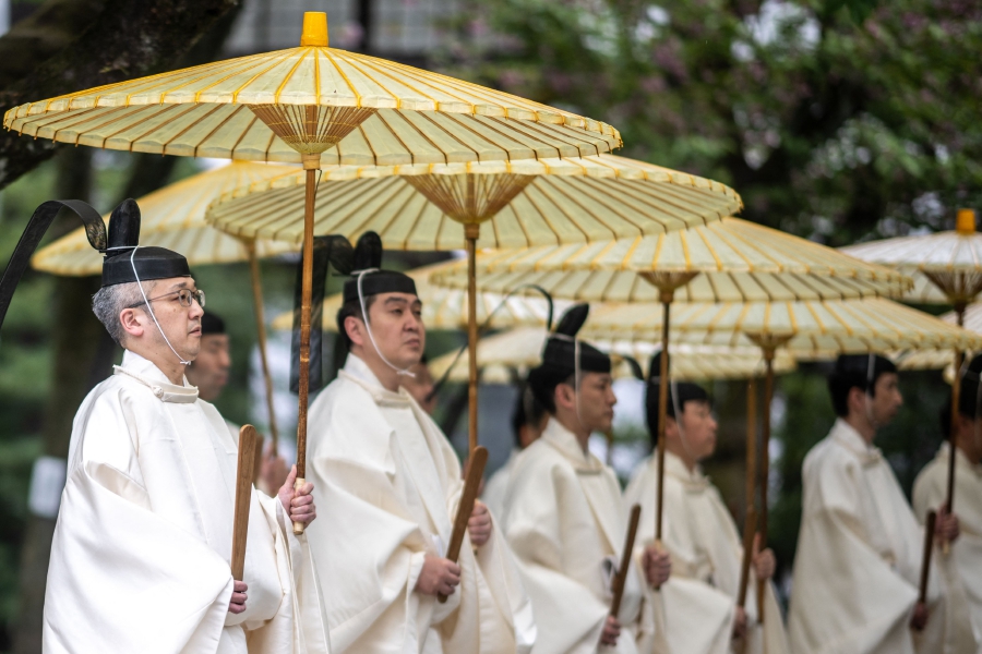 Priests take part in the annual spring rites at the Yasukuni Shrine in Tokyo. (Photo by Philip FONG / AFP)