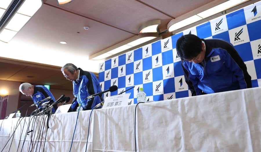 Japan's Tokyo-based Space One President Masakazu Toyoda (centre) and others bow their heads during a press conference regarding the launch failure of their first small satellite rocket Kairos, in Nachikatsuura Town, Wakayama Prefecture. (Photo by JIJI Press / AFP) 