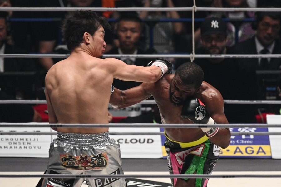 US boxer Floyd Mayweather (R) fights against Japanese mixed martial artist Mikuru Asakura during their exhibition boxing match at the Saitama Super Arena in Saitama. - AFP pic