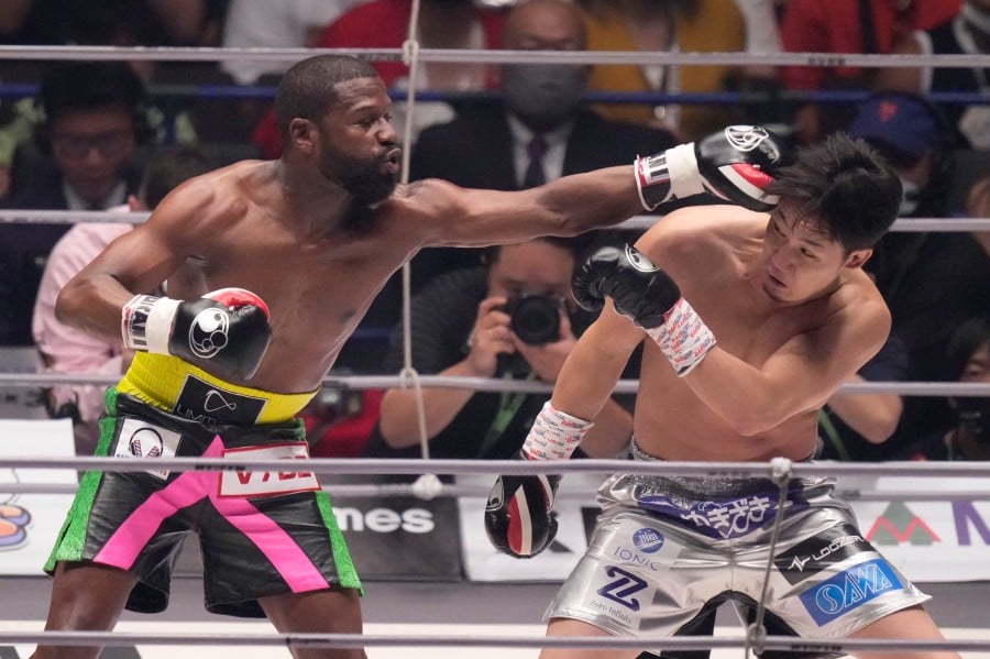 Boxer Floyd Mayweather of the U.S. throws a punch against mixed martial artist Mikuru Asakura of Japan in Saitama, north of Tokyo, Sunday, Sept. 25, 2022. - AP pic