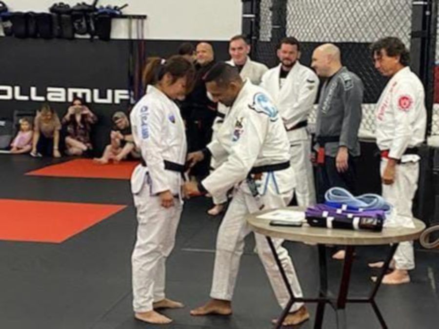 Angie getting her belt from Coach Professor Denilson Pimenta in Naples, Florida. Picture courtesy of ANGIE BARTHOLOMEW