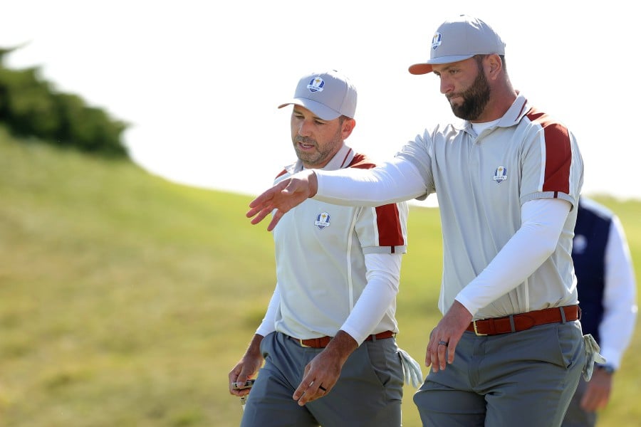 Sergio Garcia of Spain (L) and Jon Rahm of Spain and team Europe walk off the third green during Saturday Morning Foursome Matches of the 43rd Ryder Cup at Whistling Straits on September 25, 2021 in Kohler, Wisconsin. - AFP PIC
