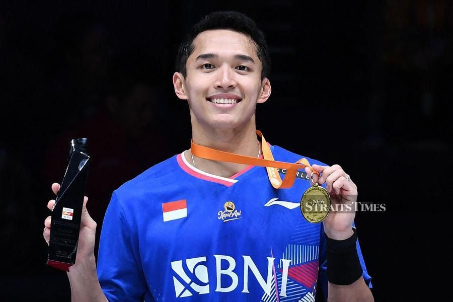 Indonesia’s Jonatan Christie poses on the podium after winning the men's singles final match against China’s Li Shifeng at the Badminton Asia Championships in Ningbo, in eastern China's Zhejiang province on April 14, 2024. - AFP pic