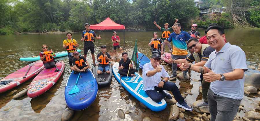 Kiulu assemblyman Datuk Joniston Bangkuai with stand-up paddlers at the Kipumpun Riverside Camp and Stand-Up Paddle Tourism Centre in Kiulu. Picture courtesy of Sabah Tourism Board