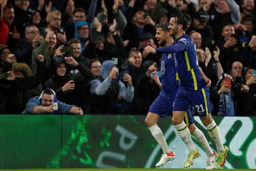 Chelsea's Italian midfielder Jorginho (L) celebrates scoring his team's fourth goal from the penalty spot with Chelsea's English defender Ben Chilwell during the Champions League group H football match between Chelsea and Malmo FF at Stamford Bridge in London. - AFP PIC