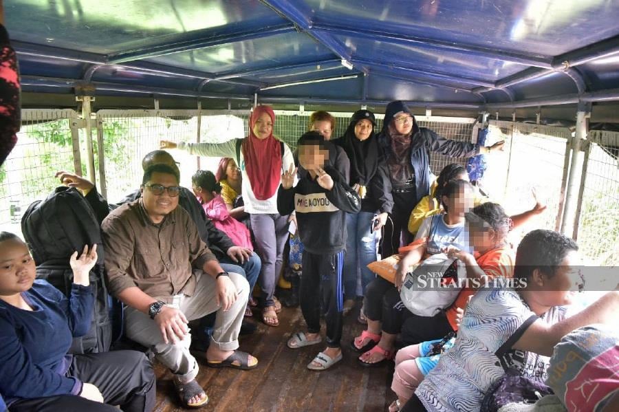 The three journalists who entered an Orang Asli settlement in Kuala Betis here, have been rescued after about six hours stranded due to the floods. - NSTP/ PAYA LINDA YAHYA