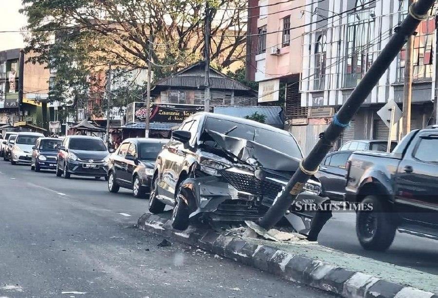 A woman miraculously escaped serious injury after losing control of her Perodua Alza, which then collided with an electric pole on Jalan Kampung Sireh.- Pic credit: NSTP/SHARIFAH MAHSINAH