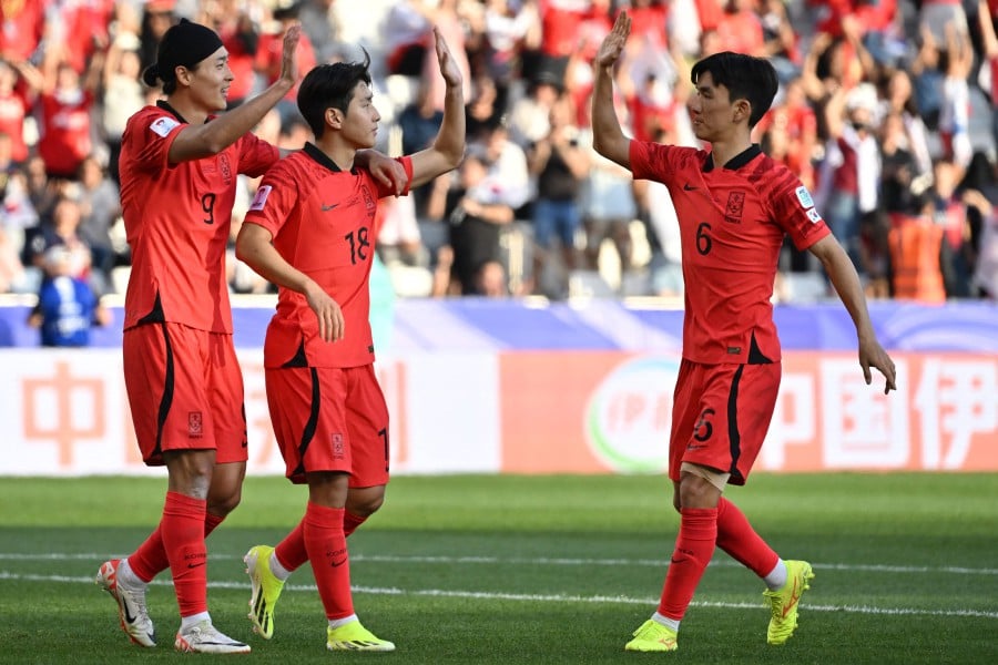 South Korea's midfielder (2nd left) Lee Kang-in celebrates with teammates after scoring his team's third goal during the Qatar 2023 AFC Asian Cup Group E football match between South Korea and Bahrain at the Jassim bin Hamad Stadium in Doha. - AFP pic