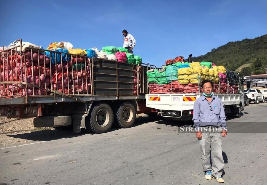 Kundasang farmer Simon Leong, 52, who went viral in giving out tonnes of vegetables in viraled Twitter Video. - NSTP/Courtesy of Simon Leong