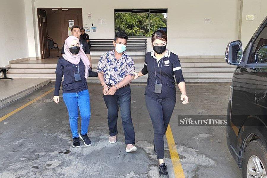 Noor Azimah Jan Badiol Zaman (center) was sentenced to two years imprisonment for inducing a 16-year-old illegal immigrant to apply a MyKad using her son’s birth certificate. - NSTP/courtesy of Sabah NRD
