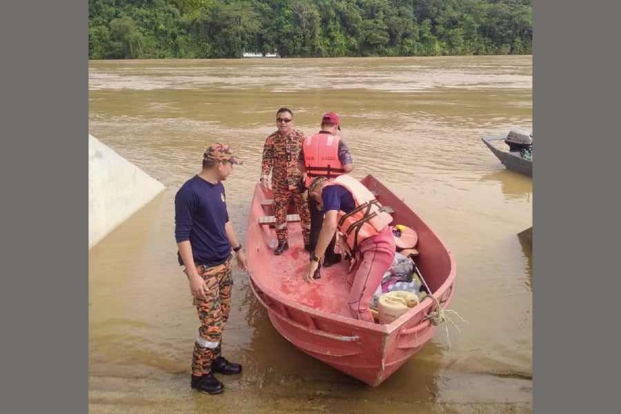 Fire and Rescue Department personnel prepare to set out on the third day of the search for the four men reported missing after the boat capsized Thursday at the confluence of the Rajang and Baleh rivers. - Pic courtesy of the Sarawak Fire and Rescue Dept