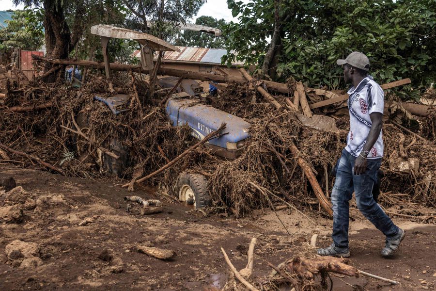 A man walks next to a damaged tractor carried by waters in an area heavily affected by torrential rains and flash floods in the village of Kamuchiri, near Mai Mahiu, on April 29, 2024. - Kenya said on Sunday that the death toll from weeks of devastating rains and floods had risen to 228 and warned that there was no sign of a let-up in the crisis. - AFP pic