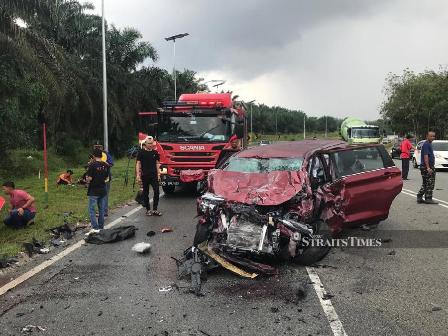 A woman was killed and nine others were injured in an accident involving a Perodua Alza and a passenger van along Jalan Mawai, near here, today. - Pic courtesy of Fire and Rescue Dept