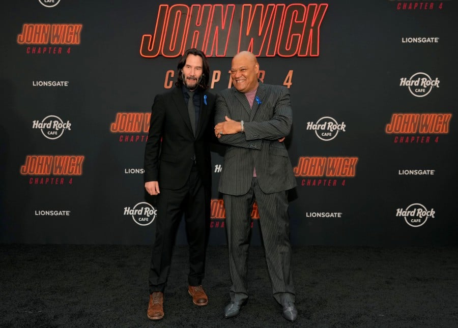 Keanu Reeves, left, and Laurence Fishburne, cast members in "John Wick: Chapter 4," pose together at the premiere of the film, Monday, March 20, 2023, at the TCL Chinese Theatre in Los Angeles. - AP pic