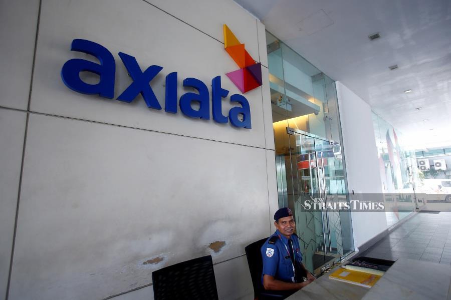 FILE PHOTO: A security officer guards in front of the Axiata headquarters buiding in Kuala Lumpur. REUTERS/Samsul Said