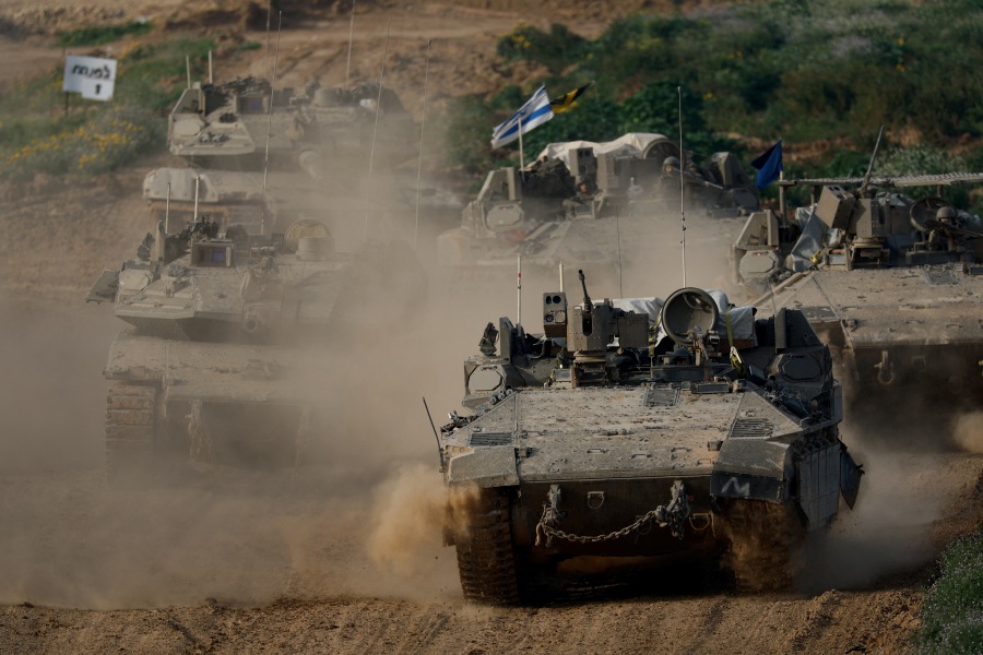 Israeli army vehicles return from the southern Gaza strip, in southern Israel. - Reuters pic