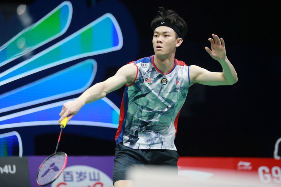 Lee Zii Jia hits a return to Japan's Kenta Nishimoto during their men's singles quarter final match of the BWF World Tour China Masters 2023 badminton tournament in Shenzhen, in China's southern Guangdong province. - AFP pic