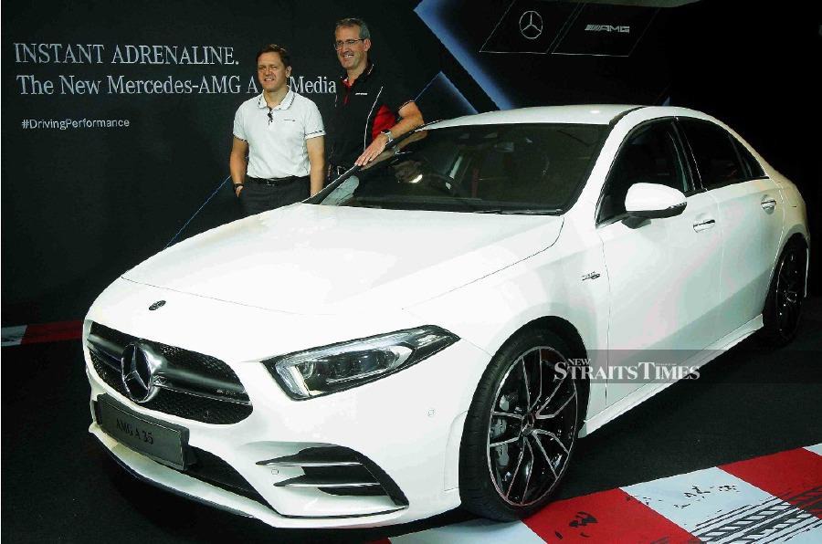 President & CEO, Dr. Claus Weidner (left) and Vice President, Sales & Marketing Michael Jopp (right) with Mercedes-AMG A 35 4 Matic launched at Petronas Gallery Suria KLCC. - NSTP/SAIFULLIZAN TAMADI.