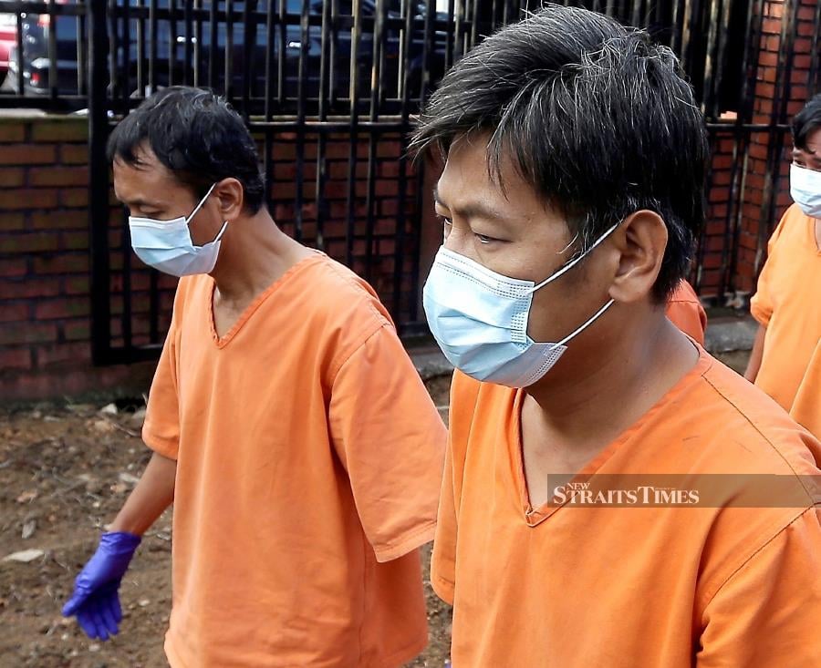 Ship captain Myint Aung (left), a Myanmar national, and Singaporean Seah Tien Lye pleaded not guilty after the charge was read in English in front of Magistrate Nur Azzuin Abdul Moati. - STR/NUR AISYAH MAZALAN