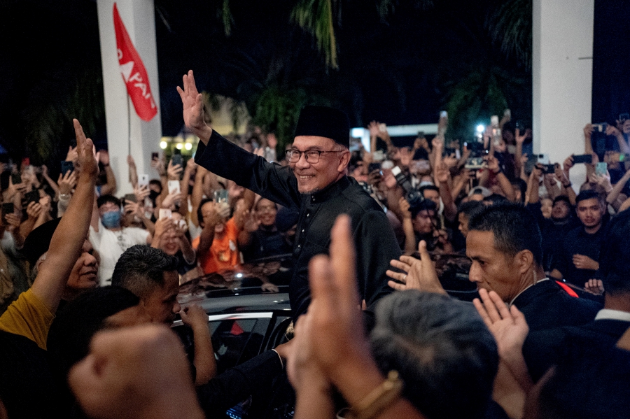Malaysia's newly appointed Prime Minister Anwar Ibrahim waves to his supporters after his news conference in Sungai Long, Selangor, Malaysia. (Office of Anwar Ibrahim/Sadiq Asyraf/Handout via REUTERS)