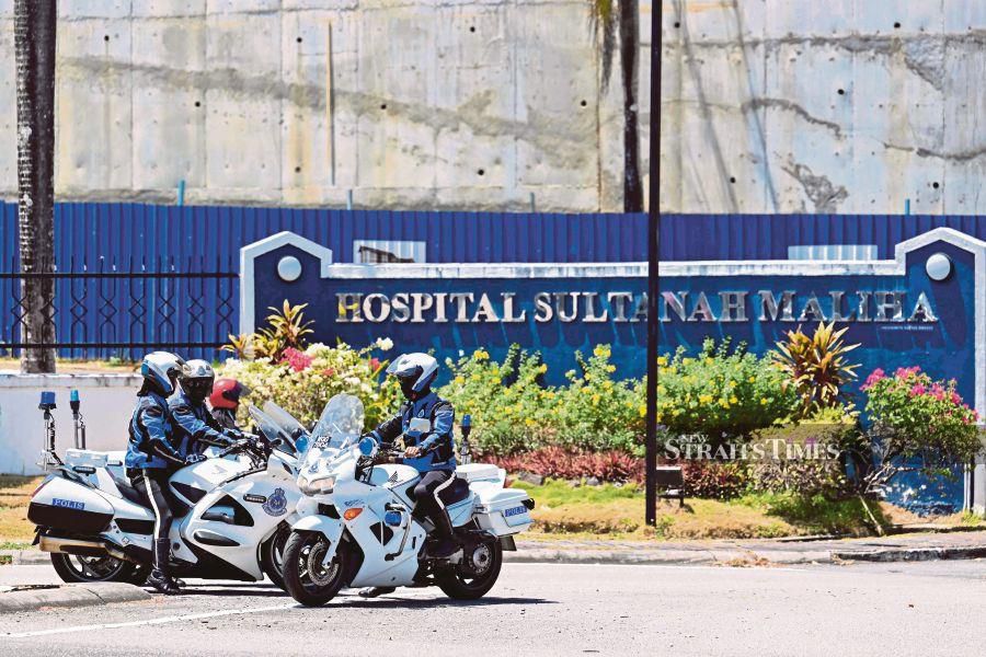 Royal Malaysia Police on motorbikes prepare to leave after a vehicle with diplomatic license plates entered Sultanah Maliha Hospital, where Norway's King Harald has been admitted with an infection, on the Malaysian resort island of Langkawi. (Photo by Mohd RASFAN / AFP)