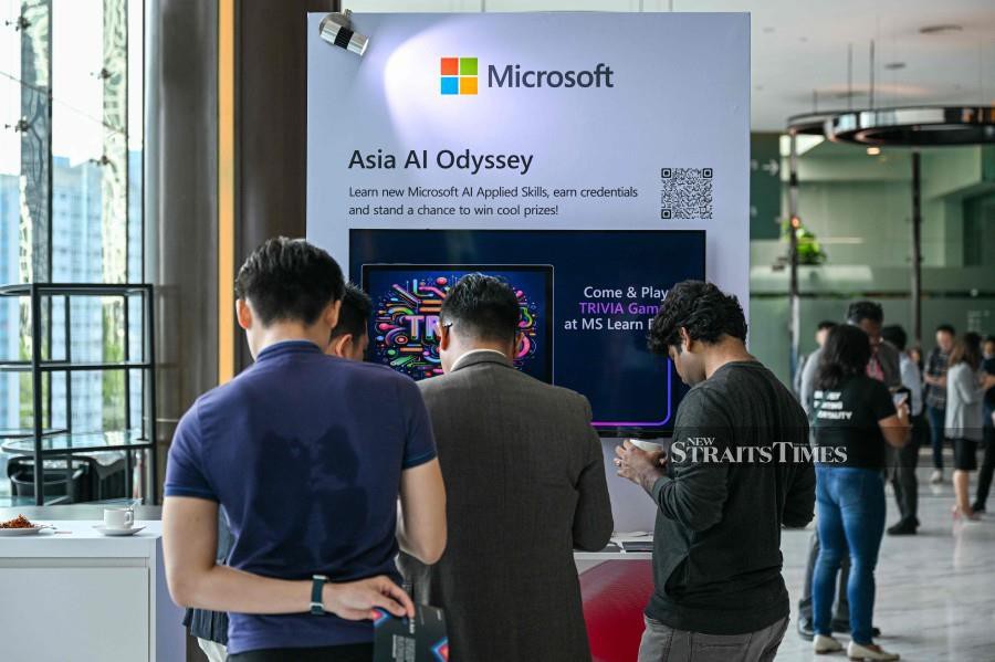 Participants check a Microsoft booth before CEO Satya Nadella's speech during an event named Microsoft Build AI Day in Kuala Lumpur on May 2, 2024. (Photo by Mohd RASFAN / AFP)