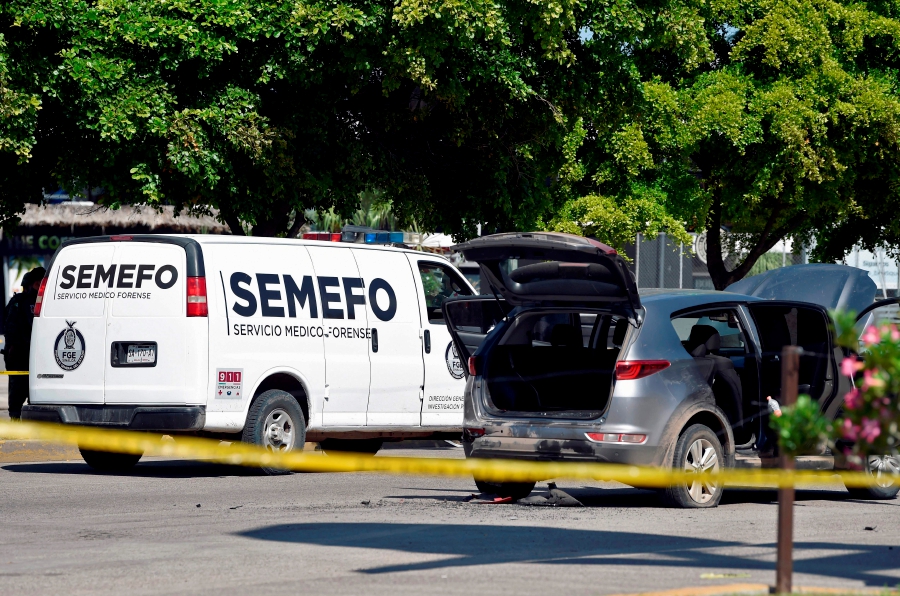 A forensic service van is seen at a cordoned-off area after heavily armed gunmen waged an all-out battle against Mexican security forces in Culiacan, Sinaloa state, Mexico, on October 18, 2019.-AFP