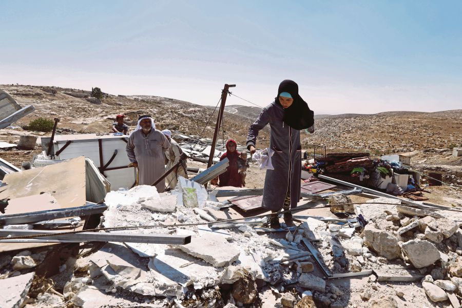 Palestinians collect their belongings after Israeli authorities demolished Palestinian houses in the West Bank village of Mufagara, near Hebron, 11 September 2019. The Israeli army deny Palestinians from building and infrastructure in area C of the west bank since they do not have the Israeli needed permits.- EPA Pic