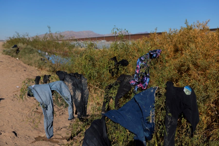 Clothes belonging to migrants who crossed the Rio Bravo river in search of asylum in the United States hang at the border between Mexico and the United States, in Ciudad Juarez, Mexico on Friday (Dec 20). — REUTERS