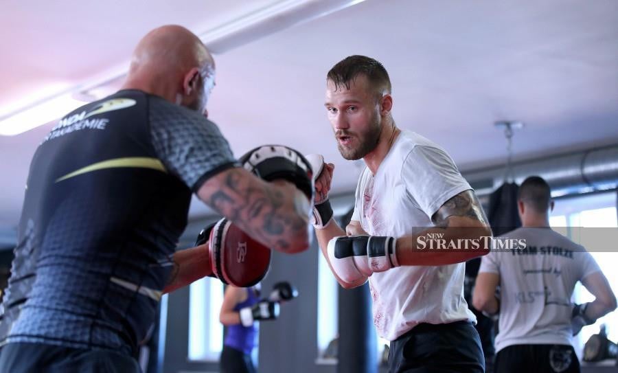Germany's Pro MMA (mixed martial arts) fighter Niklas Stolze (right) takes part in a training session with head coach Sascha Poppendieck at the La Onda Fight Club in Magdeburg, eastern Germany. The 27-year-old Welterweight nicknamed "Green Mask", will make his Ultimate Fighting Championship (UFC) debut on July 25, 2020 in Abu Dhabi, United Arab Emirates. Having sparred with Ultimate Fighting Championship legend Conor McGregor earlier in his career, Germany's Niklas Stolze now wants to step up and make his own mark in UFC. AFP photo
