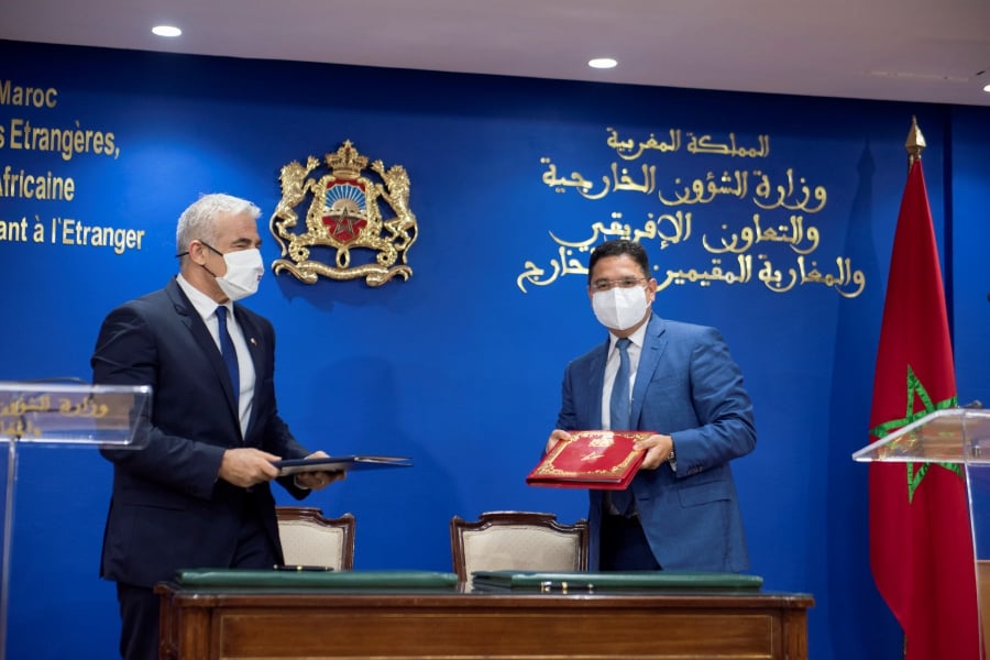 Moroccan Foreign Minister Nasser Bourita (right) and his Israeli counterpart Yair Lapid sign cooperation agreements in Rabat, Morocco, on 11 August 2021. - EPA/JALAL MORCHIDI